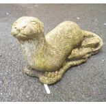 A 60cm cast concrete model of a recumbent otter