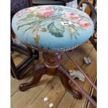 A Victorian rosewood adjustable piano stool with upholstered seat and screw action to pillar, set on