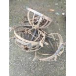 Four wrought iron hanging flower baskets