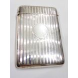 A silver visiting card case with engraved stripe decoration and blank cartouche