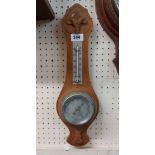 A 20th Century small oak mounted banjo barometer/thermometer with aneroid works