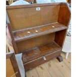 A 58cm vintage stained mixed wood two shelf open bookcase with fall-front drawer under