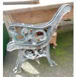 A pair of green painted cast iron bench ends