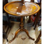 A Victorian mahogany wine table, set on turned pillar and triple cabriole legs