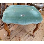 A Victorian style oak framed dressing stool with piped green velour upholstered seat, set on