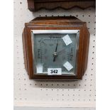 A vintage oak mounted Shortland Bros. aneroid wall barometer with moulded border