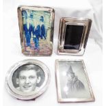 Four small silver fronted photograph frames (the largest to take 14cm X 9cm), all with oak easel