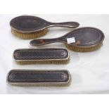 Four silver mounted tortoiseshell brushes with inlaid detail - various condition