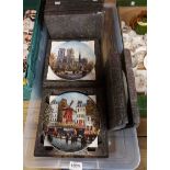 A crate containing ten Limoges collectors' plates, each decorated with a Parisian scene - in