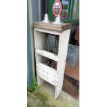A vintage double beer pump, set in white wood frame