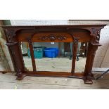 An Edwardian walnut overmantel mirror with applied decoration and flanking fluted pillars with