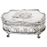 A silver dressing table trinket box with Art Nouveau embossed decoration and cherub group to