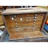 A 46cm vintage Neslein mixed wood engineer's tool chest with an array of eight drawers enclosed by a
