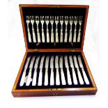 A cased set of twelve each silver fruit knives and forks with engraved blades, silver collars and
