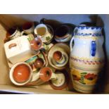 A box containing a quantity of Torquay pottery including jugs, vases, candlesticks, bowls, egg cups,