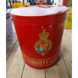 A vintage oval hat box marked for Christy's, London Hats with red leather effect paper covering