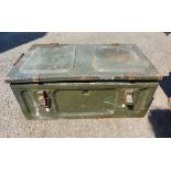 A green painted metal military transit case with latches to hinged lid, containing various tools