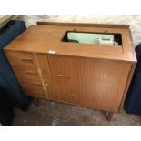 A retro teak effect cabinet cased Singer sewing machine