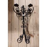 A wrought iron five branch table candelabrum with scrolling decoration and black painted finish
