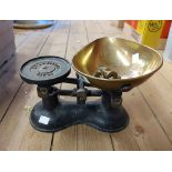 A set of vintage cast iron scales with brass pan and small quantity of brass weights