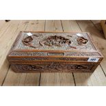 An old Chinese carved wooden lift-top box with panels depicting figures and birds on a prunus