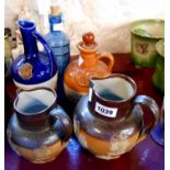 Two Doulton Lambeth salt glaze stoneware harvest jugs (one with chip to rim) - sold with two ceramic