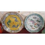 A large 20th Century Chinese dish with three dragons on a yellow ground and decorative border - sold