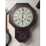 An early 20th Century mahogany cased drop dial wall clock with visible pendulum and American