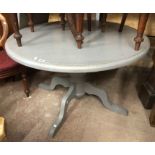 A 1.19m diameter pedestal dining table with grey painted finish, set on turned pillar and