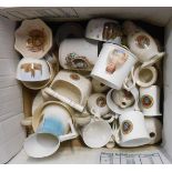 A box containing a quantity of crested ware including Goss Jersey fish basket, Grafton 'No Beer' man