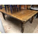 A 1.83m Edwardian oak dining table with now set top, set on turned legs with brown porcelain