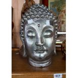 A large resin Buddha head with metallic silver painted finish