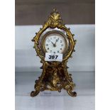 An ornate faux tortoiseshell and gilt metal mounted timepiece with battery movement