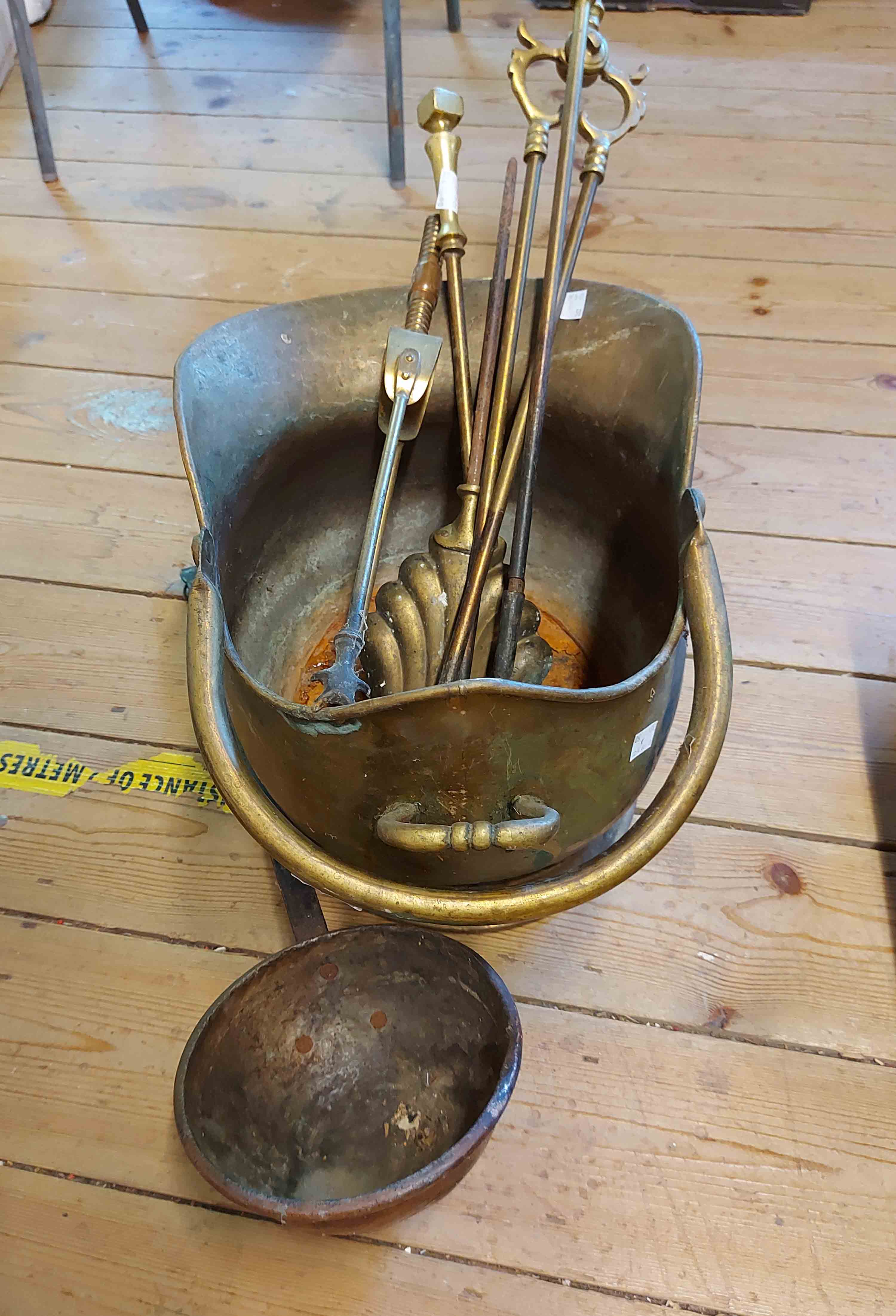 A brass helmet coal scuttle - sold with a quantity of fire irons and a copper ladle