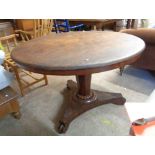 A 1.2m diameter Victorian mahogany tilt-top breakfast table, set on faceted tapered pillar and