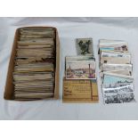 A box containing a collection of early 20th Century and other postcards including topographic,