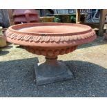A 58cm diameter terracotta garden pedestal bowl with acanthus border and decorative base