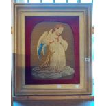 A Victorian embroidery depicting a praying angel, set in later wooden frame