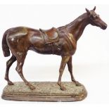 An antique spelter figurine depicting a horse with bronze effect finish