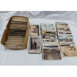 A box containing a collection of early 20th Century and other postcards including topographic,