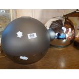 A large silvered glass lampshade of globe form - sold with a similar clear glass shade with