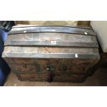 A 77cm Victorian dome-top travelling trunk with remains of tooled leather coating, wood and metal