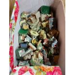 A box containing a large quantity of Tetley Tea Folk and other resin cottage models