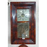 An antique mahogany cased American wall clock with etched glazed panel door and E.N. Welch thirty