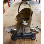 A modern brass coal scuttle of helmet form - sold with a set of cast iron scales with brass weights