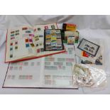 A box containing a collection of stamps including a red stock book with Victorian stamps from