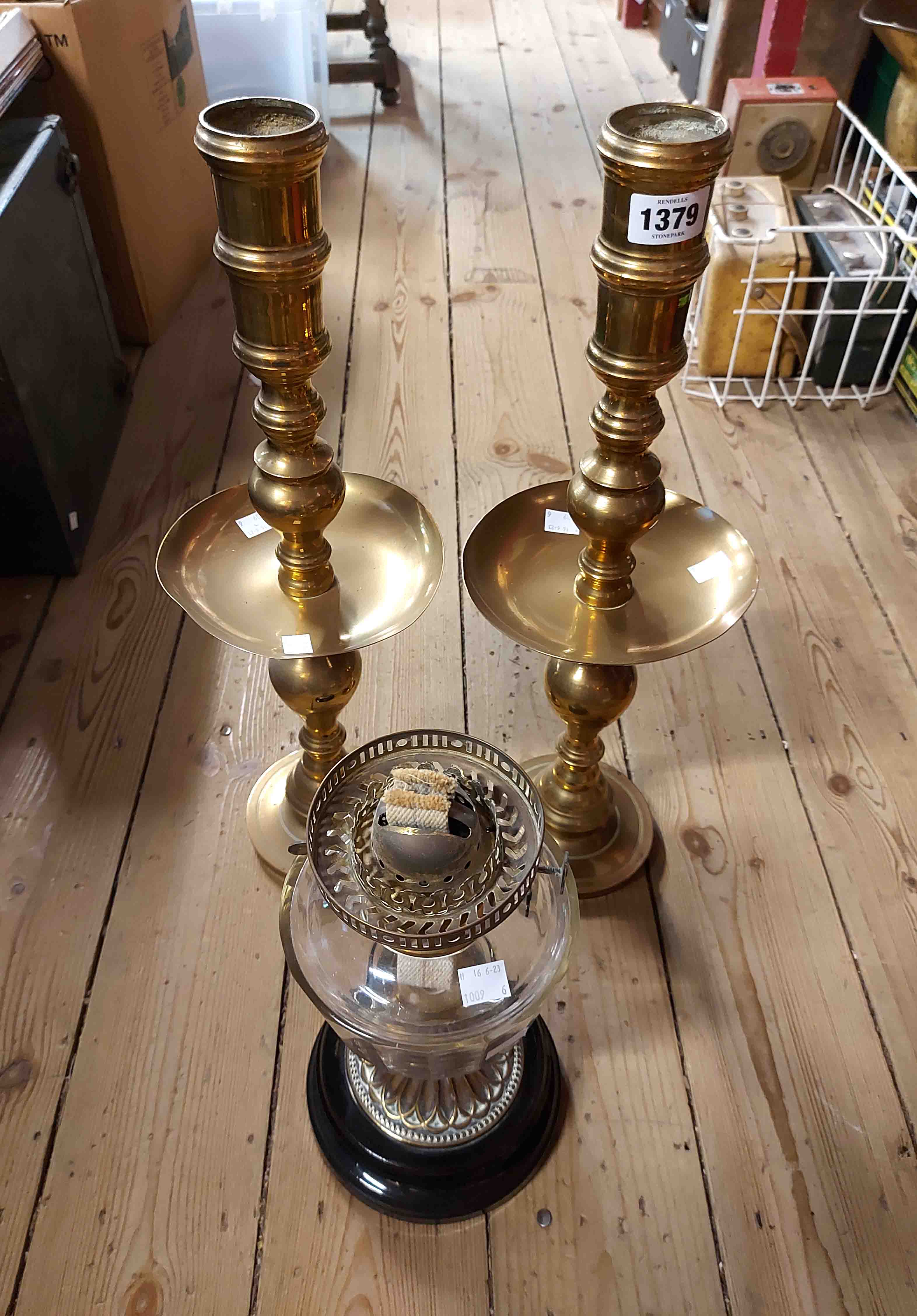 A pair of large 20th Century spun brass candlesticks with central drip trays in the antique