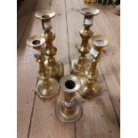 A pair of Victorian brass candlesticks - sold with a smaller similar and a single slide ejector