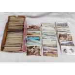 A box containing a collection of early 20th Century and other postcards including topographic,