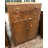 An 84cm vintage oak tallboy with two long drawers over a double cupboard, set on plinth base